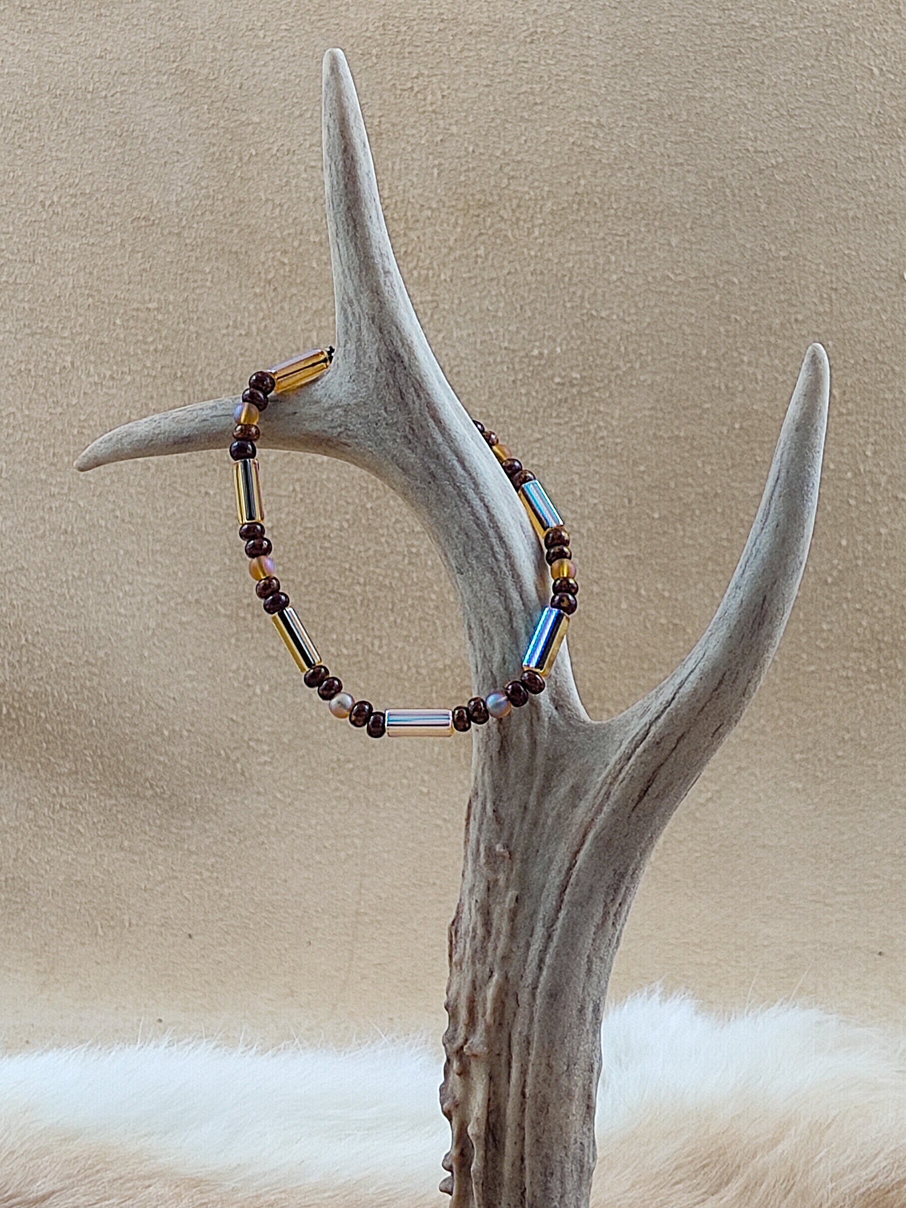 A55 Diverse glaskralen in bruin op elastiek