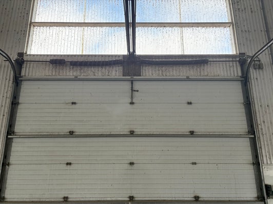 Before — fatigued torsion springs on agricultural overhead door
