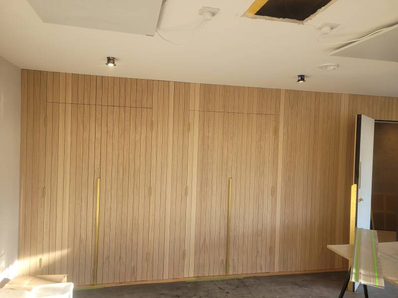 Oak cladded doors to form feature wall
