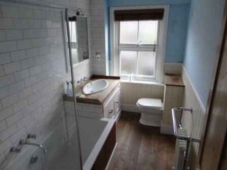Bespoke traditional style bathroom with oak flooring 