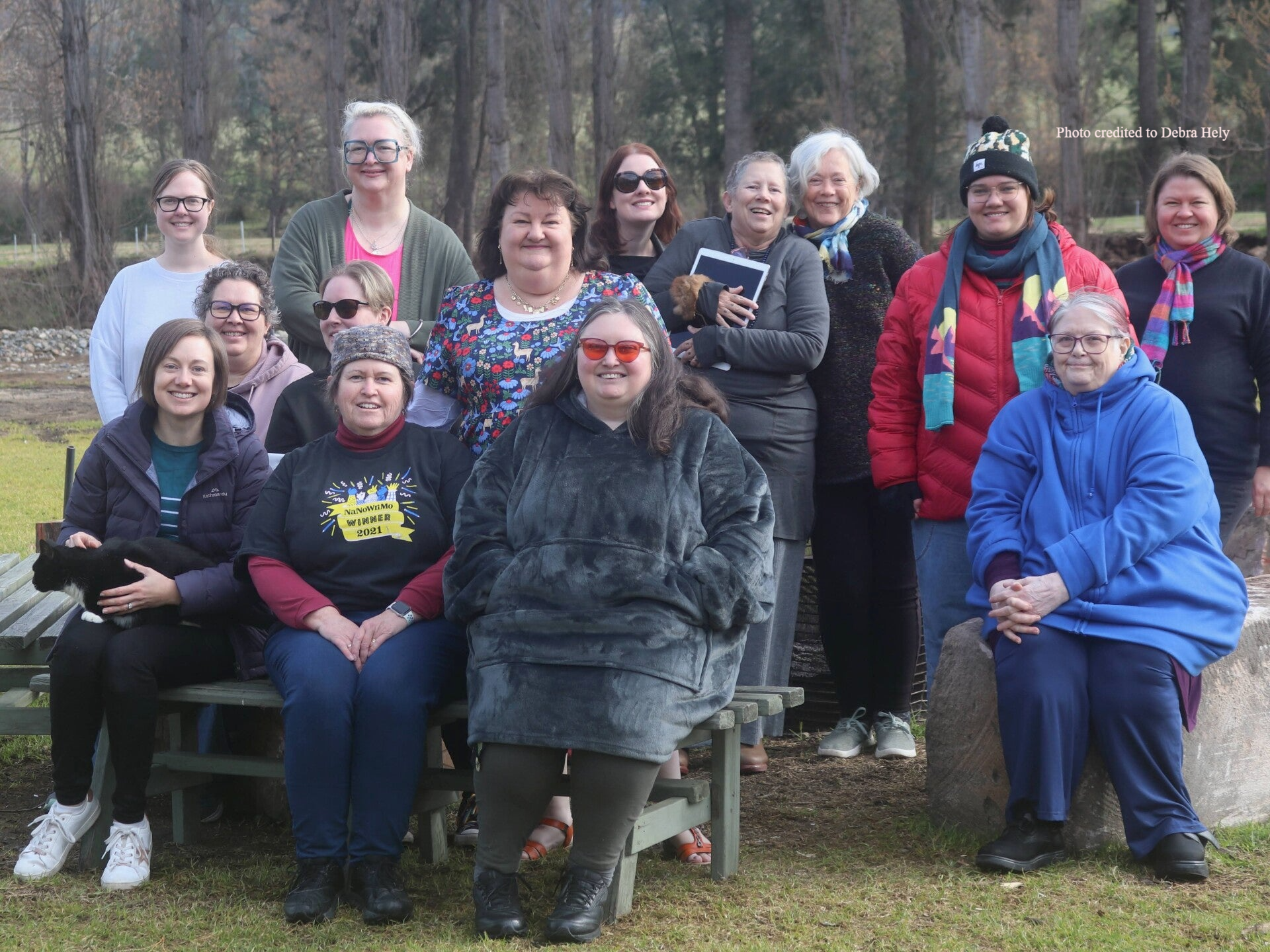 Photograph of a group of happy writers smiling after their retreat. Photo credited to Debra Hely.