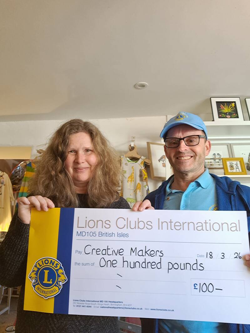 Lions cluub member handing over a cheque in donation to creative makers charity