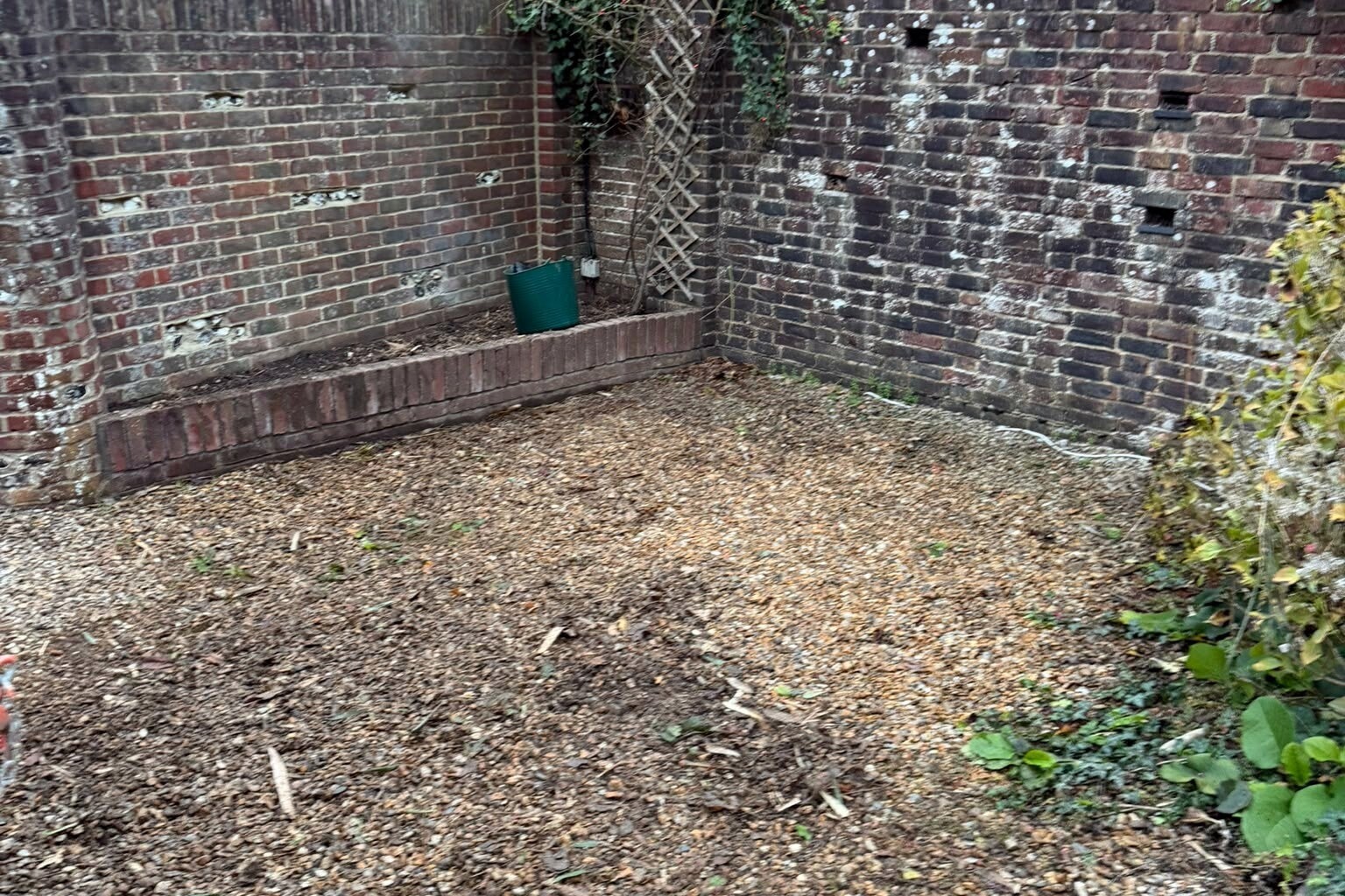 The brick raised bed in the front garden, emptied and cleared of bamboo and ready for replanting.