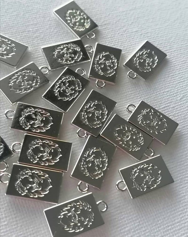 Zilveren lion kop tags per 2 stuks RVS