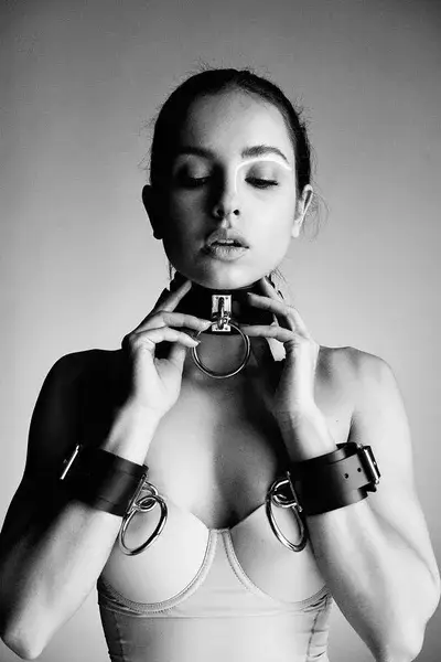 depositphotos_208100744-stock-photo-portrait-young-seductive-woman-leather-standard.webp