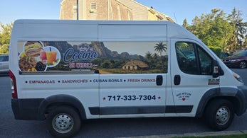 Food van with printed side graphics and commercial lettering