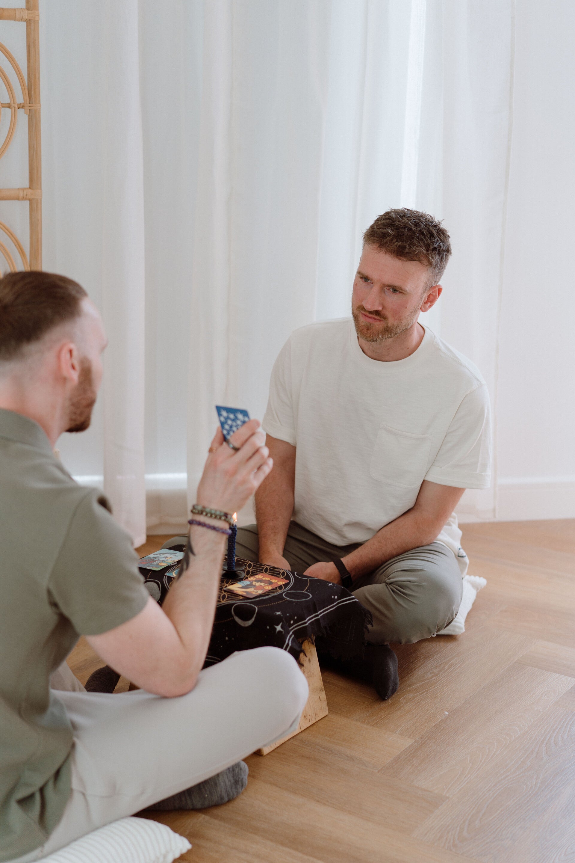 Tarot reader discussing a card during an in-person tarot reading session