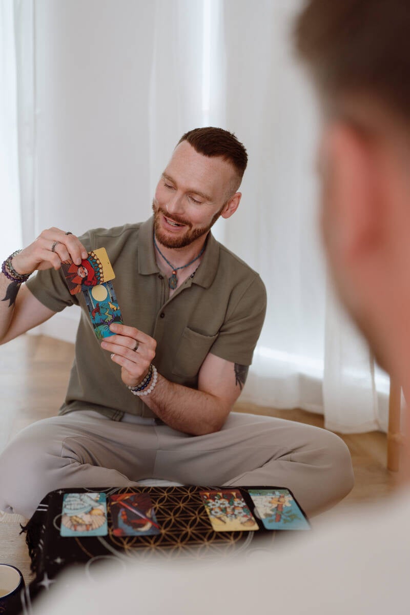 Tarot reader explaining card meanings during a tarot reading session