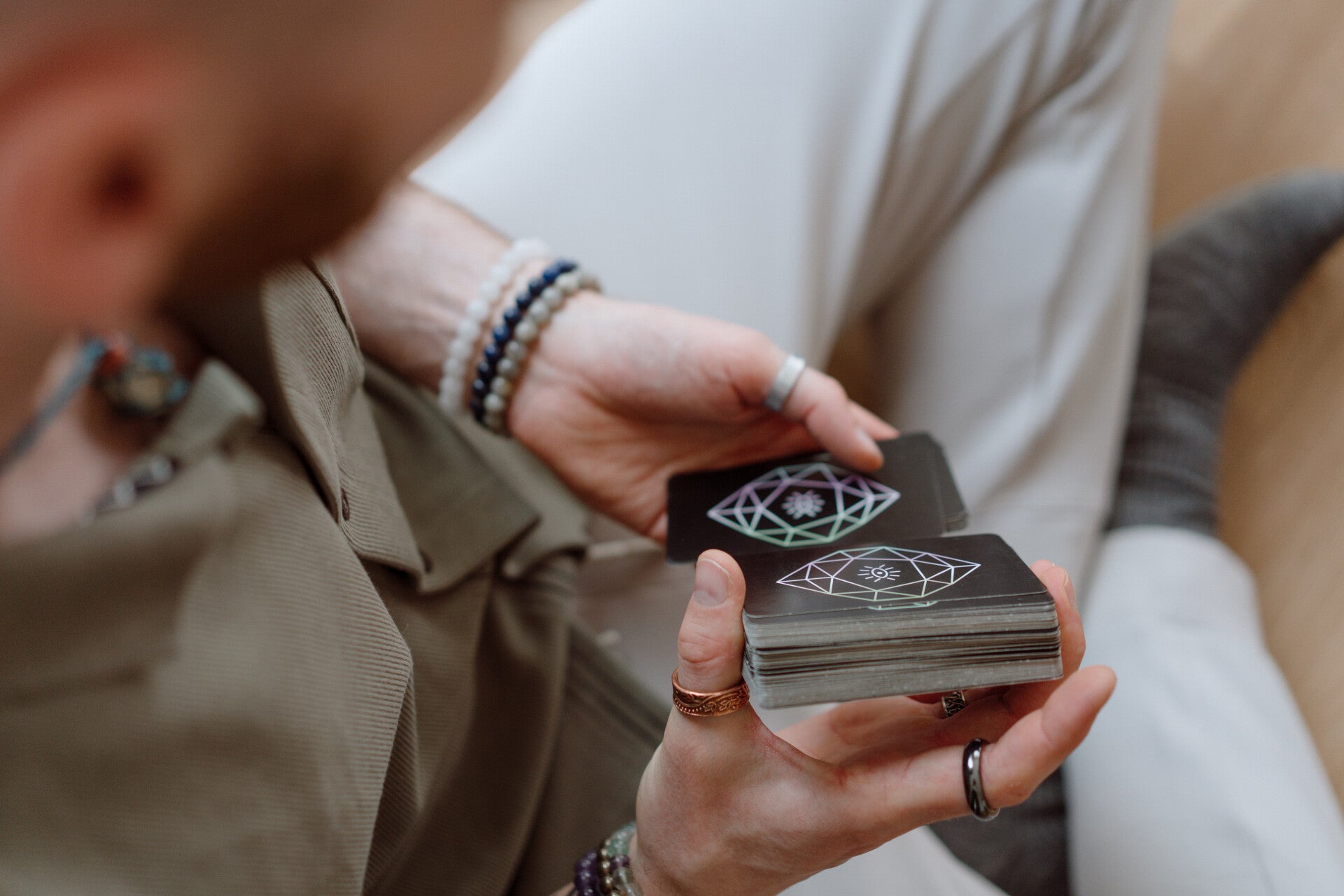 Tarot cards being held during an in-person tarot reading session