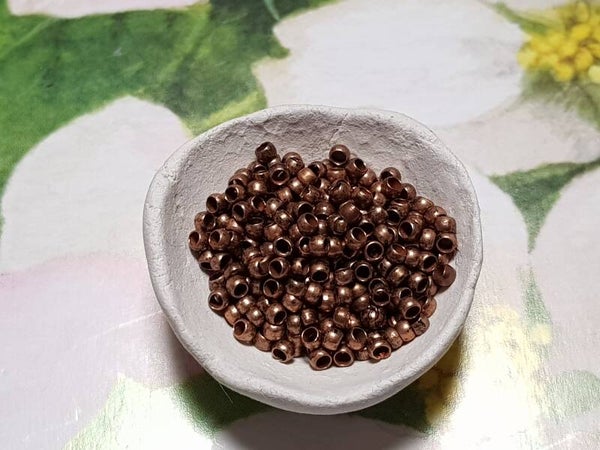 Knijpkralen 1,2mm koperkleurig