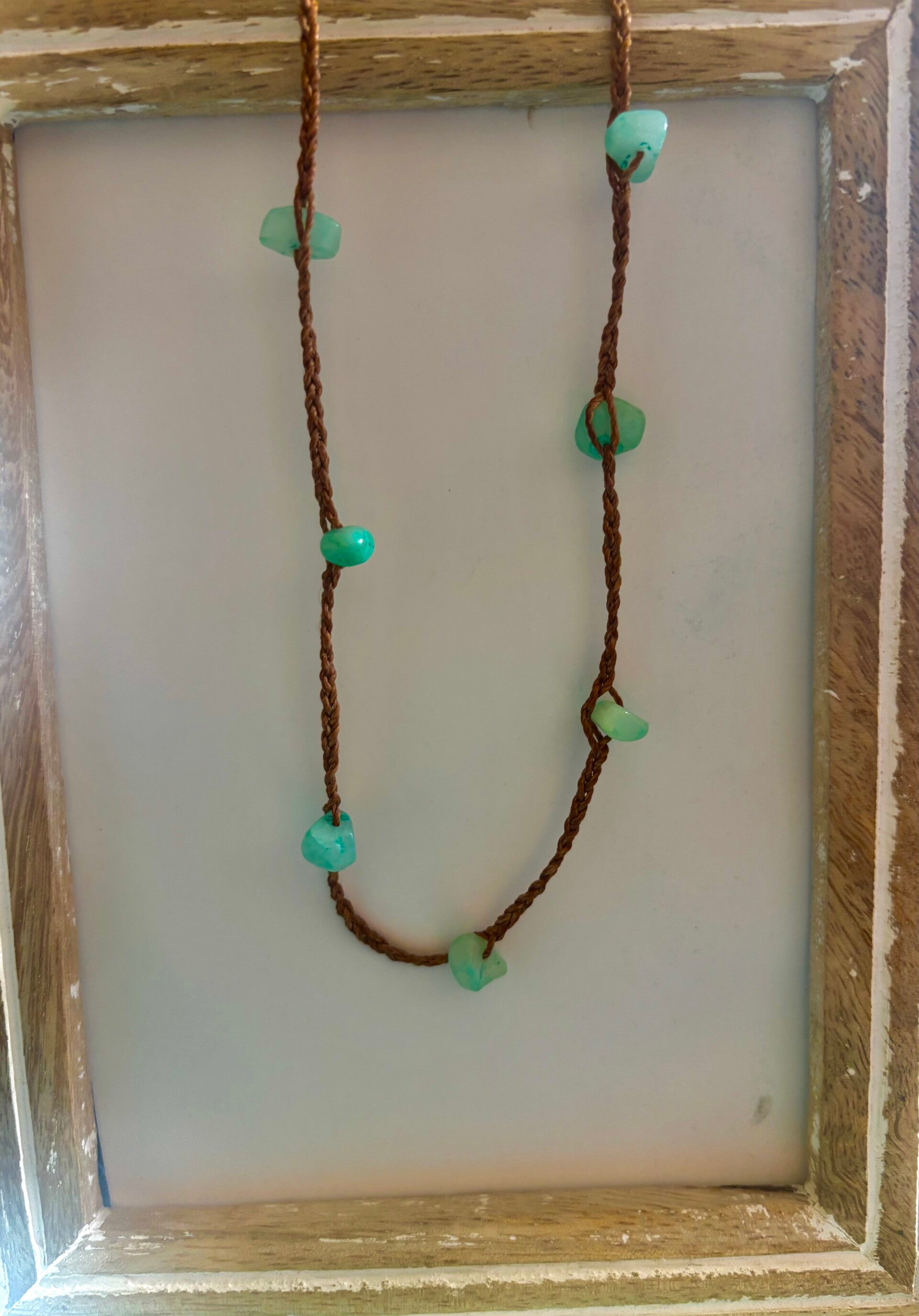 Turquoise colored stones in wax cord