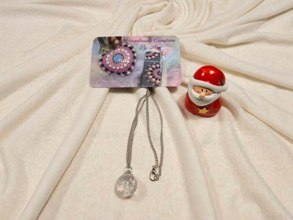 Uniek hangertje in glas gevuld met UV , sneeuwvlokjes en glitters .