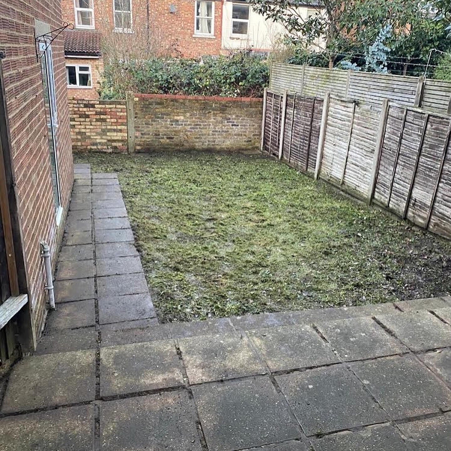 A clean, cleared London garden after a professional garden clearance service, with all overgrown brambles and green waste removed.