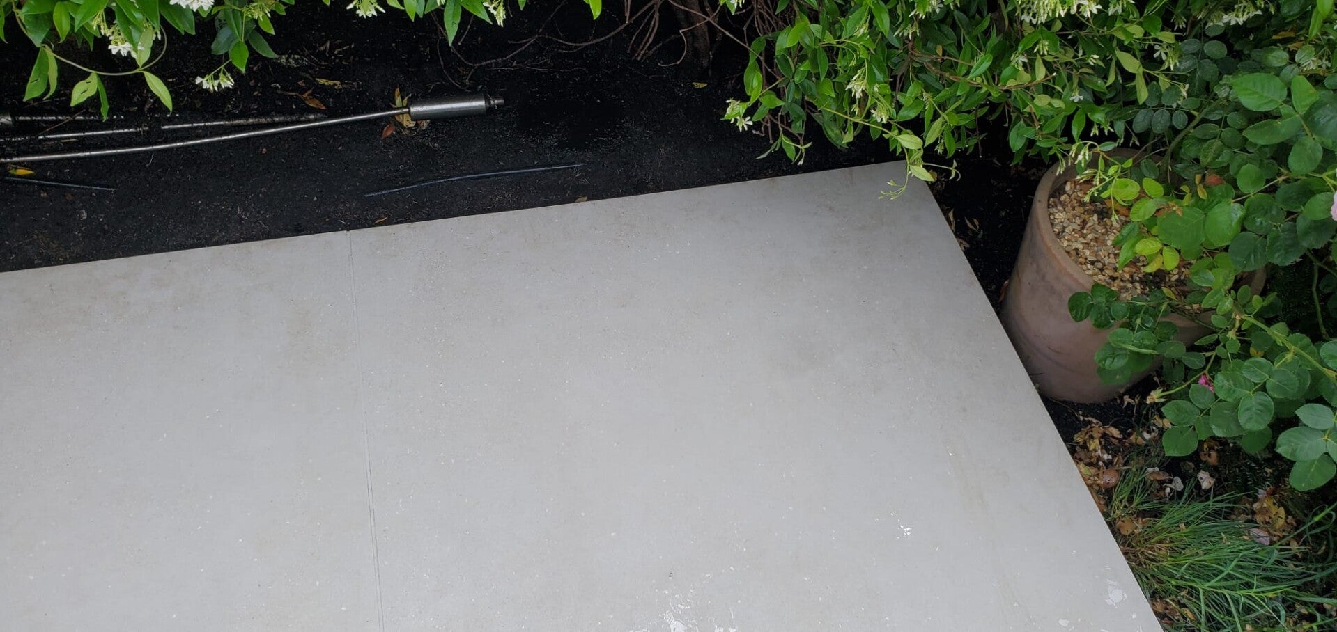 A sparkling clean white patio slab after a high-pressure jet washing service.