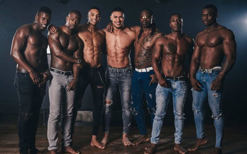 Muscular men modeling physique and masculine feet barefoot.