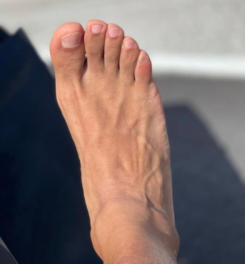 Up close man's foot size 10 pretty manicured well groomed toes.
