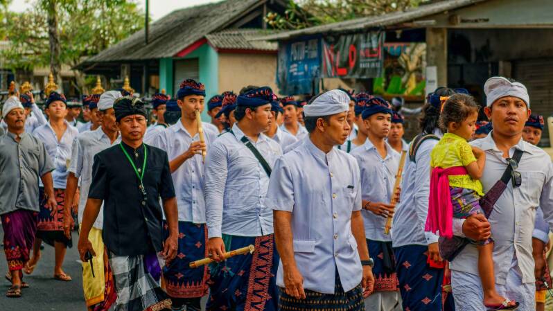 Photo of Balinese men taking part in a Hindu procession in Ubud, Bali, Indonesia