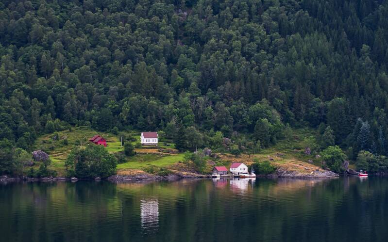 Idylic picture of green mountains and a nice wooden boat house in Vatsfjorden, Norway 