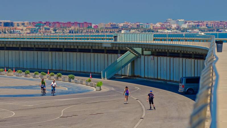 photo of a couple skating and a couple cycling in Marina Norte de Valencia, Spain