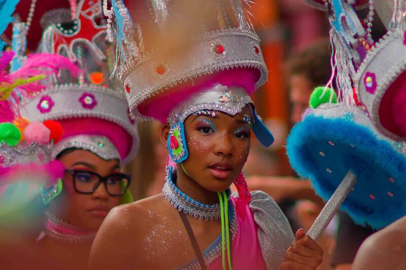  Carribean Teenager with a large headpiece is taking part in the Rotterdam Summer Carnival Parade 2024
