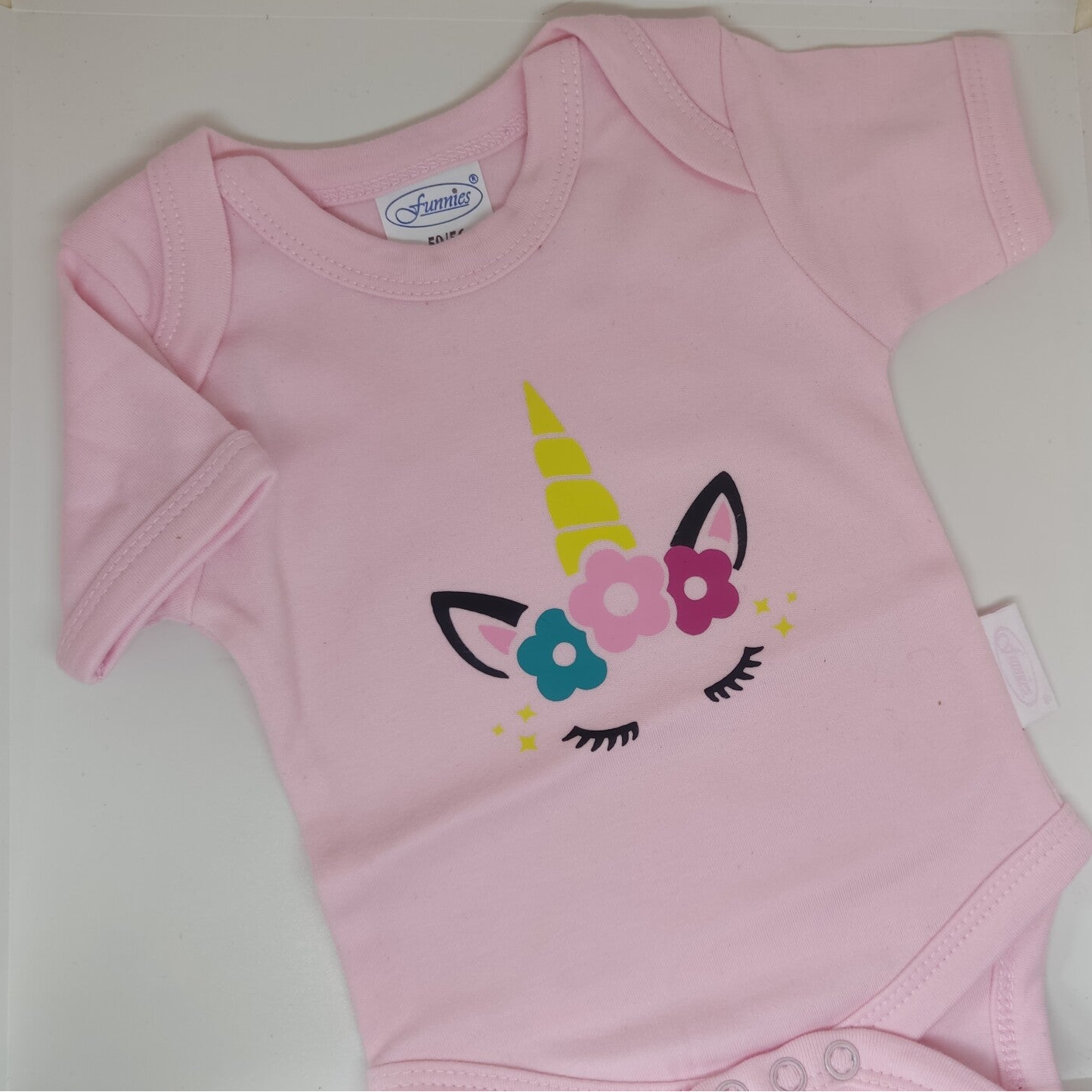 Romper licht roze of mint groen met opdruk unicorn 50/56
