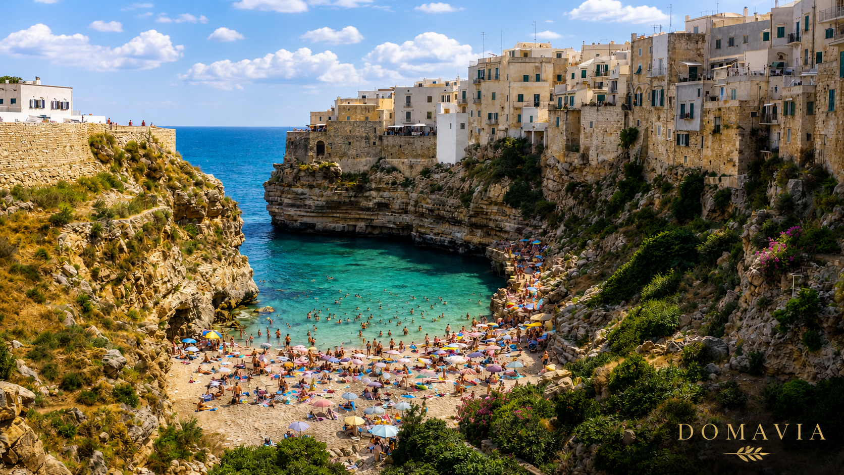 Lama Monachile beach in Polignano a Mare with turquoise Adriatic water and limestone cliffs near Valle d'Itria, Puglia.