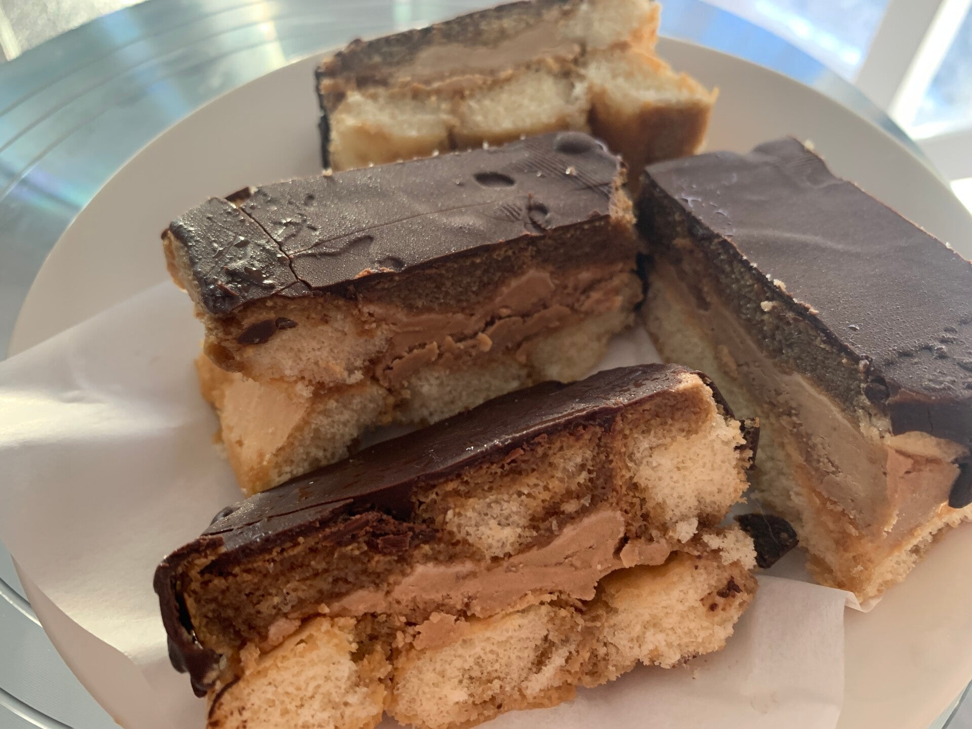 New Opéra Elegance (Vanilla & Chocolate & Coffee) A whimsy interpretation of the classic opera cake, layers of sponge soaked in coffee flavour, marbled with silky chocolate buttercream and chocolate ganache.