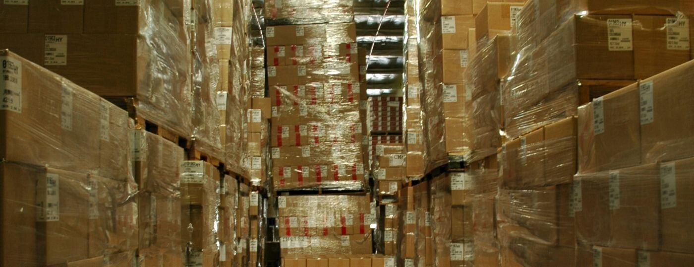 Warehouse stock shelving, boxes stacked floor to ceiling