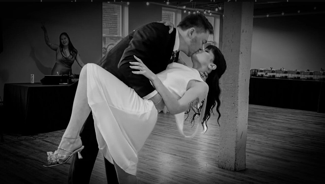 Sam and Izzy sharing a kiss on their wedding day