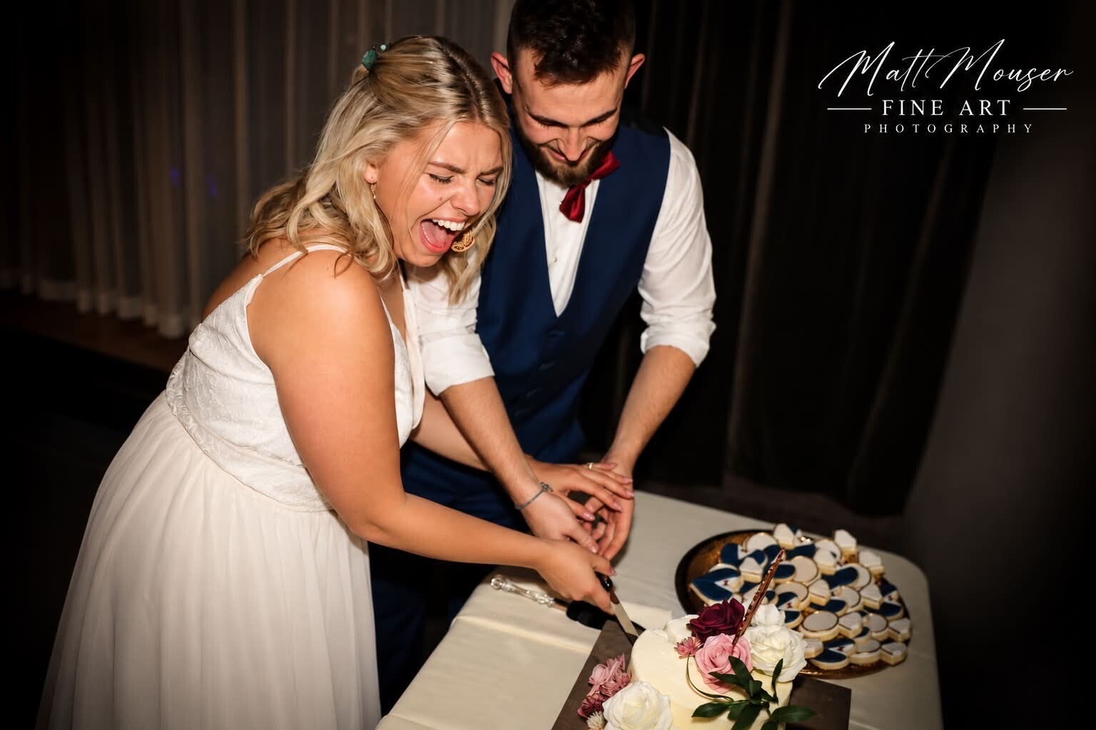 Katy and her husband cutting their wedding cake