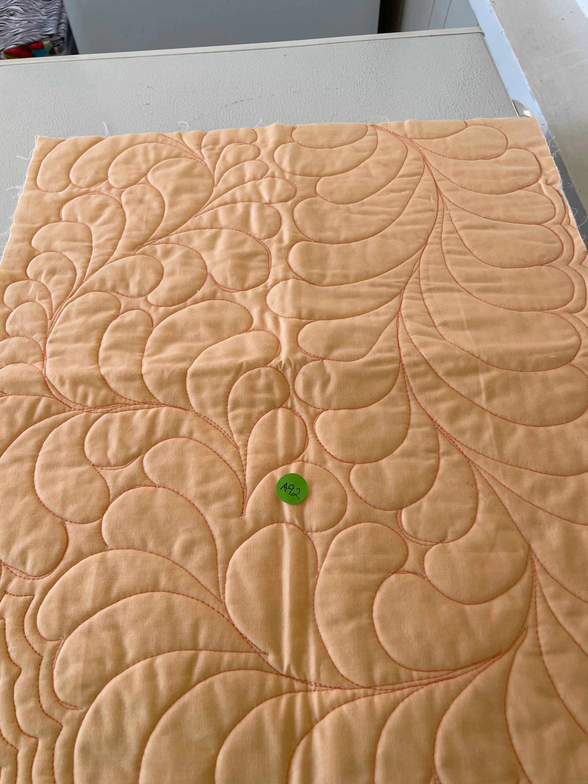 Pale Orange Solid Fabric with Orange Quilting Design Mat
