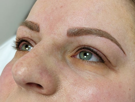 The image shows client after microblading, natural brow enhancement, and lash enhancement Semi-permanent Tattooh