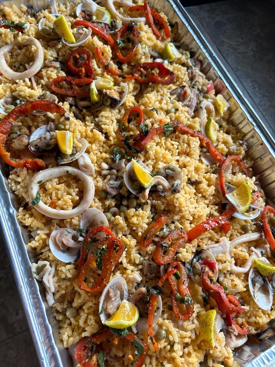 Festín de mariscos con arroz, calamares y almejas preparado por la chef
