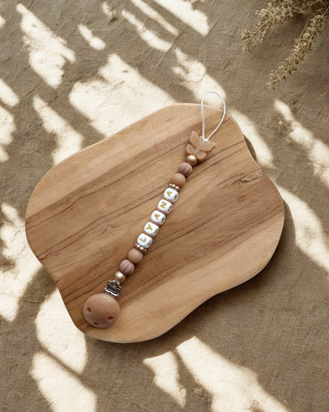 Attache tétine papillon pailleté