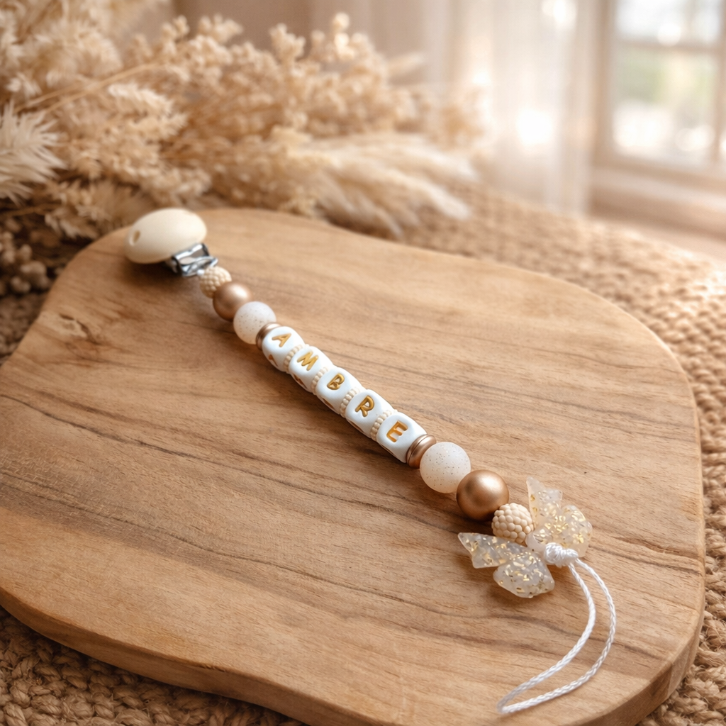 Attache tétine nœud pailletés