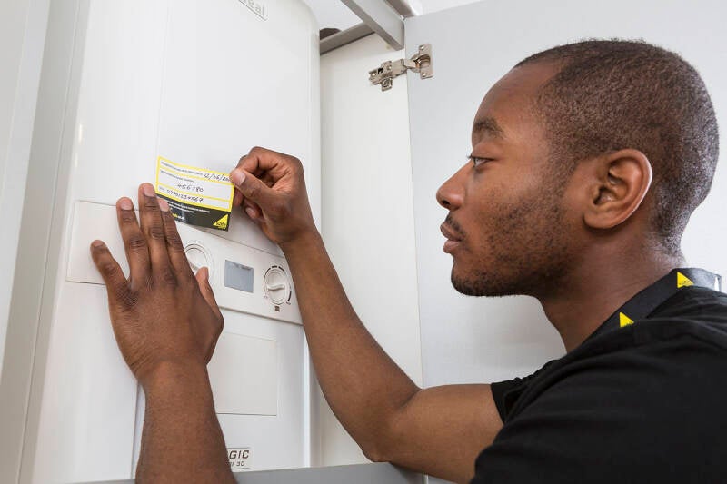 engineer-applying-annual-service-sticker-standard.jpg