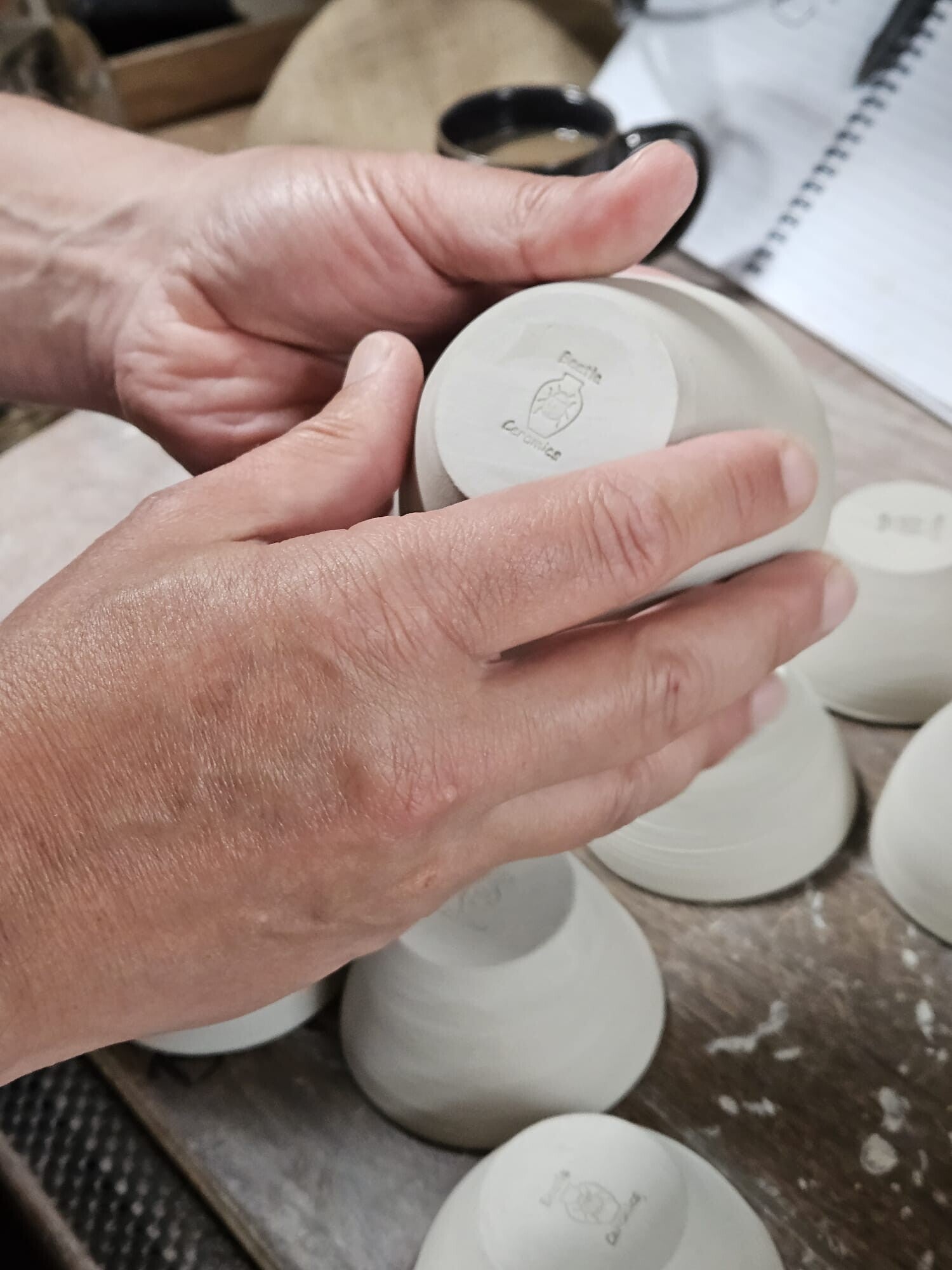 Handmade stoneware pottery being finished with a Beetle Ceramics maker’s mark