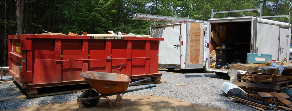 red 10 yard dumpster at a work jobsite