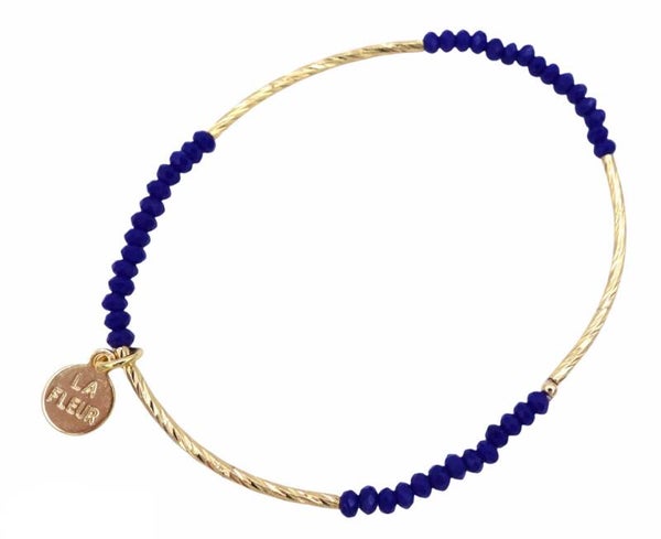 Blauwe glaskraal met gouden staafje