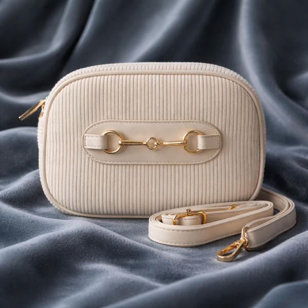 ribstof crossbody tas dames crème - ovale schoudertas met messing details - compacte trendy handtas - zachte rib stof crossbody stijl