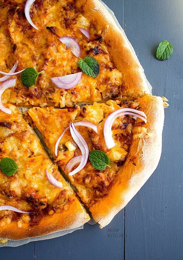 84.Butter Chicken/Paneer Pizza
