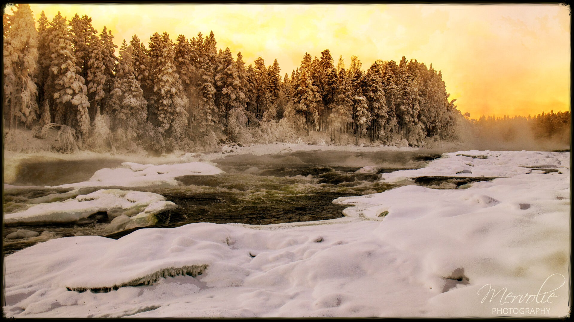 The golden light catching the mist is absolutely beautiful. The frozen cascades and snow-draped surroundings create a magical scene that feels almost otherworldly.