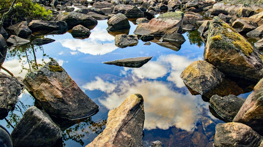 See the sky with clouds in the water