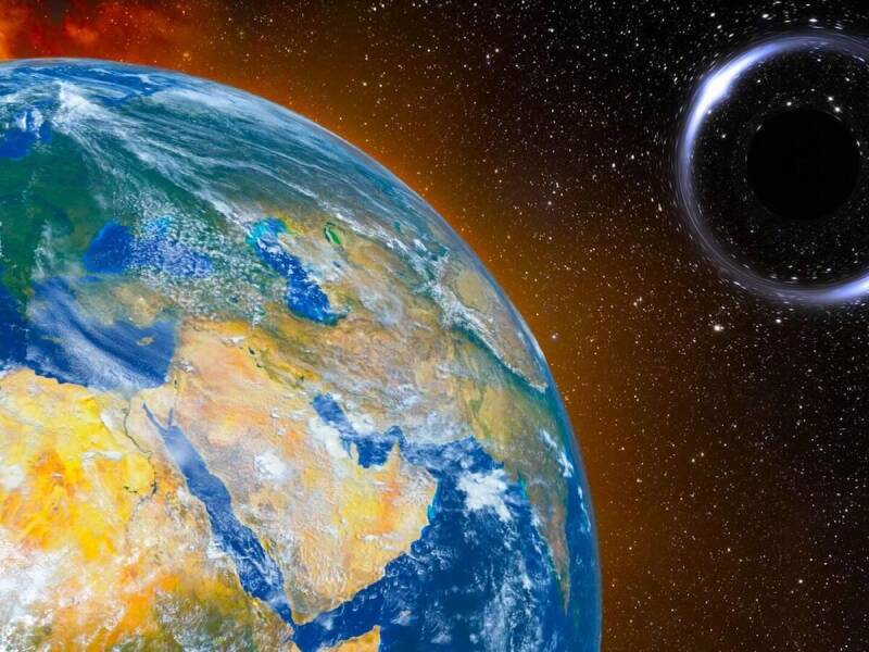 Earth viewed from space with a distant black hole far beyond the Solar System.