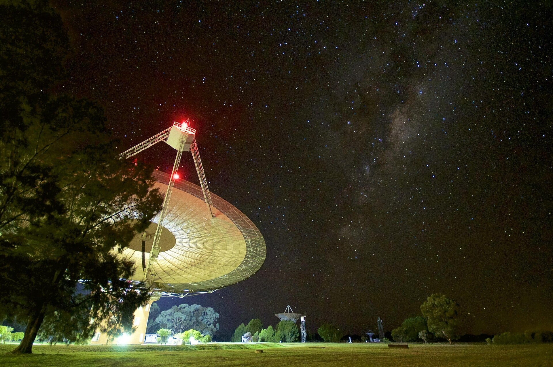 Radio telescope observing signals from distant neutron stars to study extreme physics.