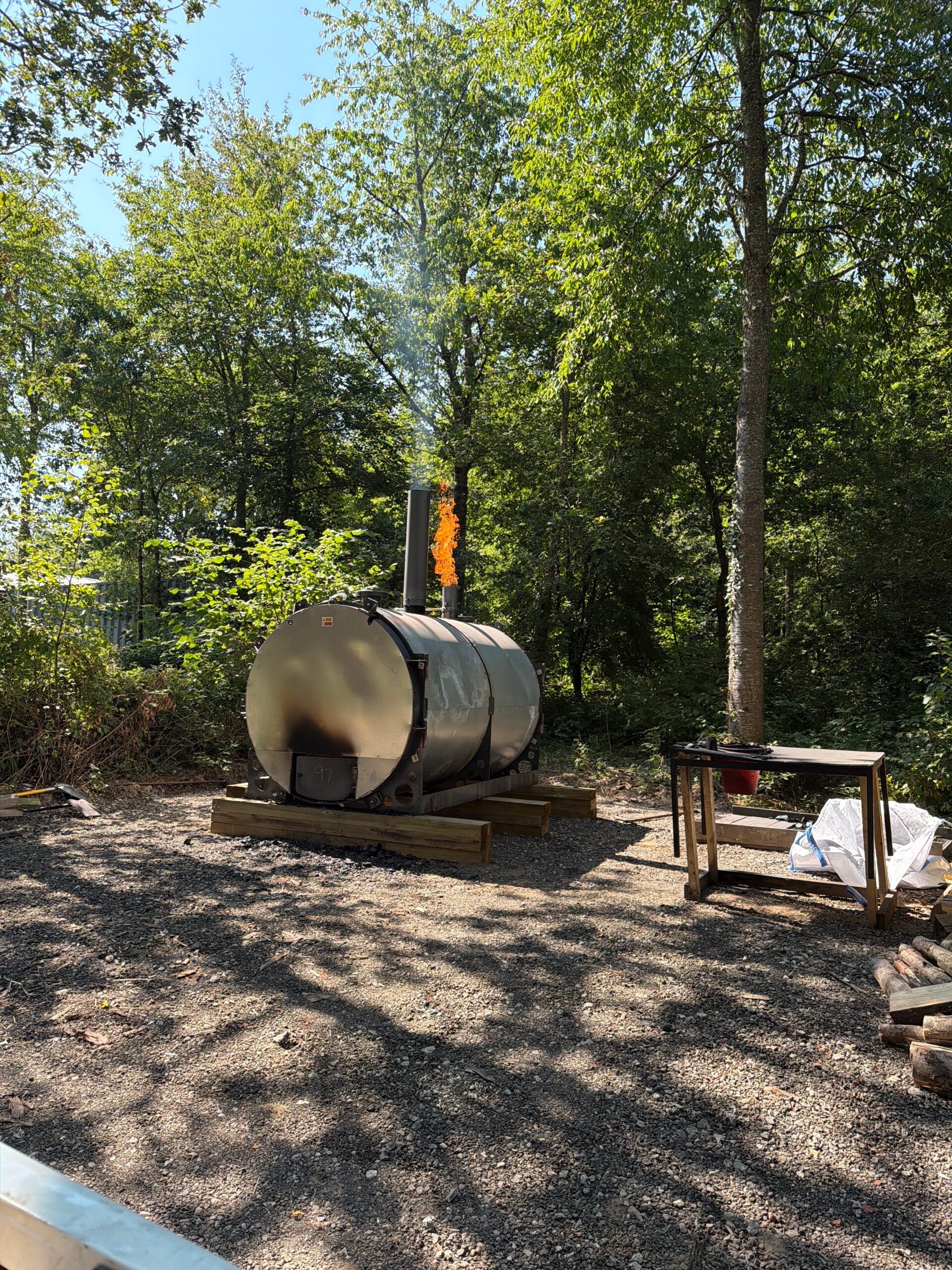 Traditional charcoal kiln producing sustainable Chiddingfold lumpwood charcoal in managed British coppice woodland.