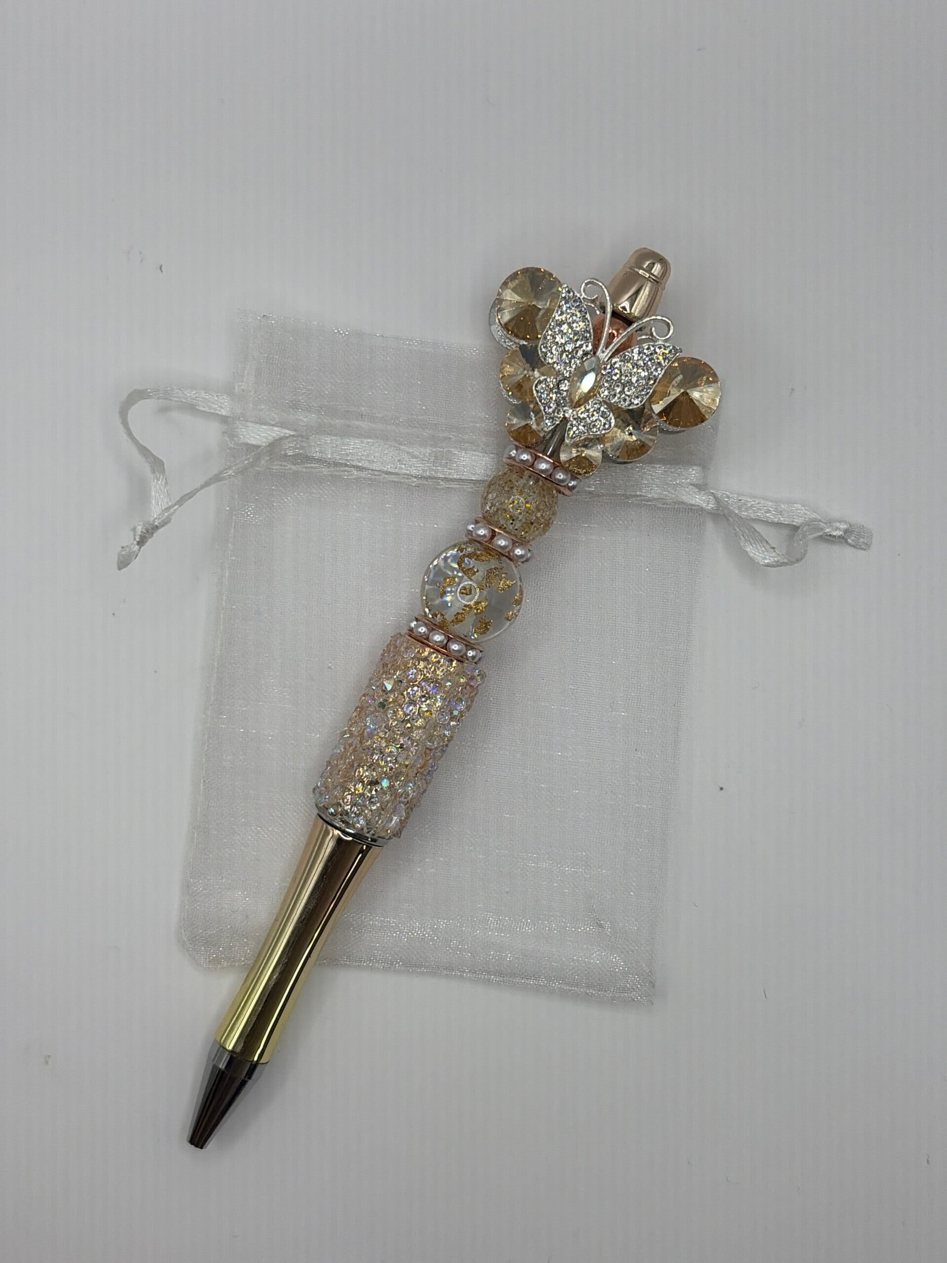 Pen goudkleurig met suikerrand en grote fancy vlinder