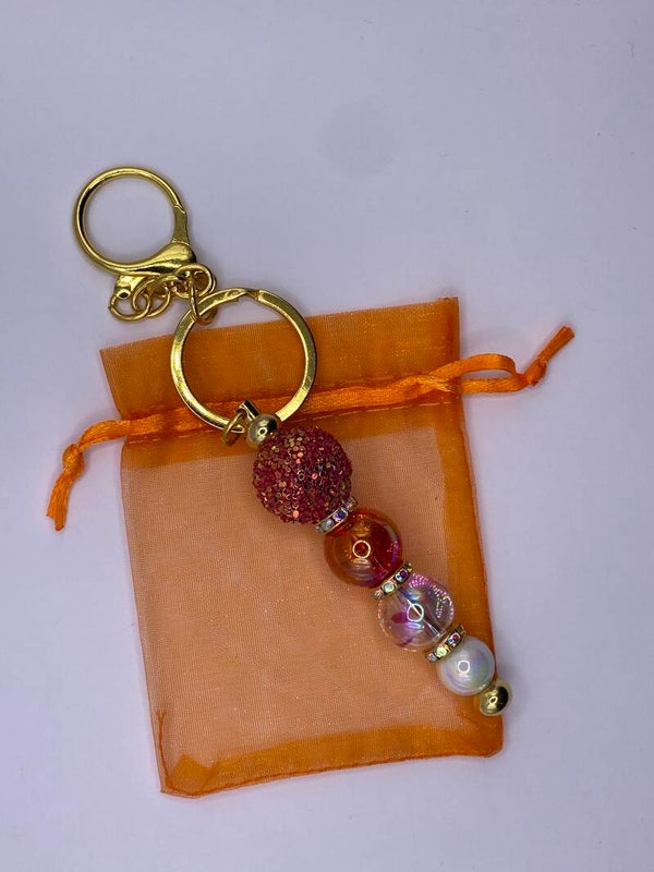 Sleutelhanger goudkleurig met rood glitter kralen