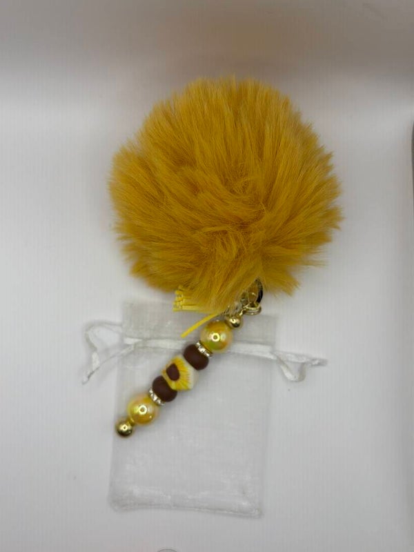 Sleutelhanger tashanger goudkleurig met zonnebloem en pompom