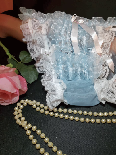 Blue nylon thong with ruffles, fringes and satin bows.